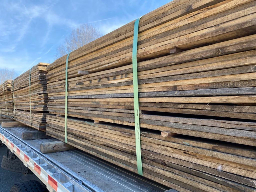 A large pile of wood on a truck.