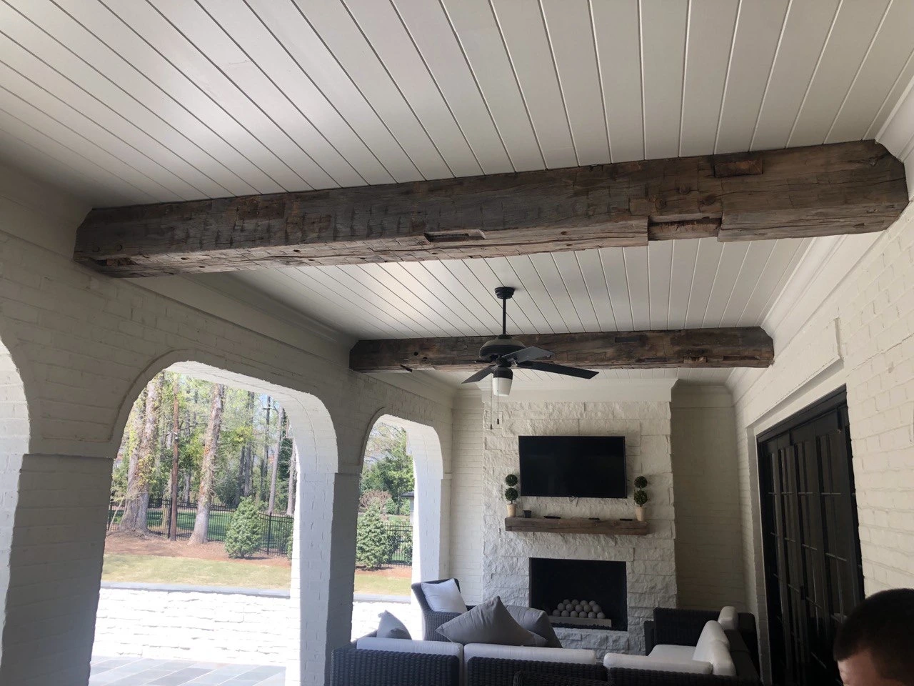 A living room with wood beams on the roof