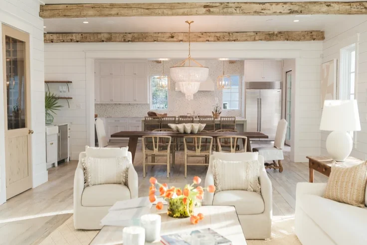A white living room with reclaimed wooden beams.