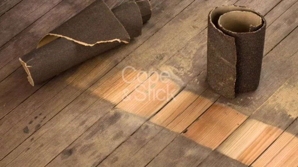 A sanded wooden floor with a sandpaper grit