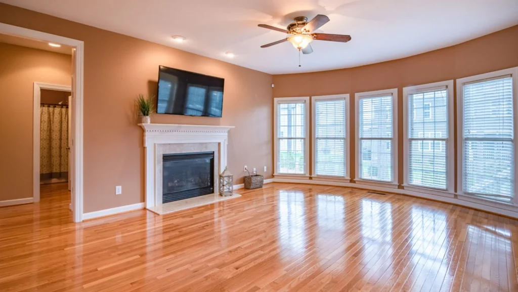 A home interior with hardwood flooring stained with a glossy finish