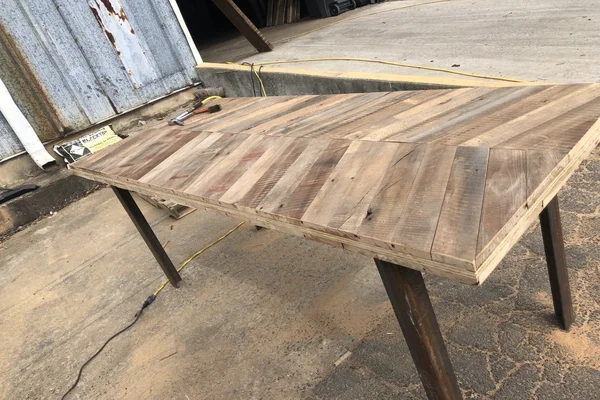 Reclaimed wood table witha cheveron pattern